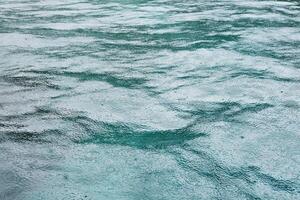 Fresh of the rain falling on the sea surface with feeling of relaxation and peace in tropical natural seasonal photo