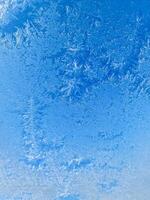 Ice crystals creating stunning winter patterns on frozen surface photo