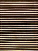 Rusty metal grille creating repeating horizontal lines photo