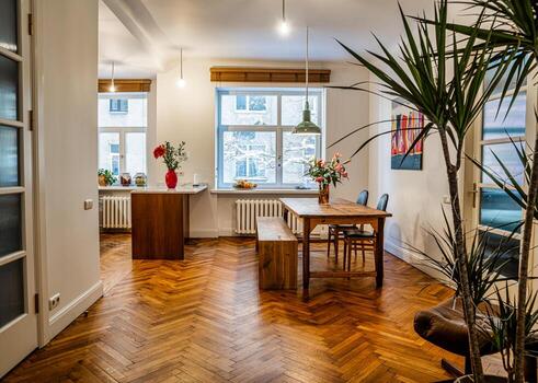 Riga, Latvia, 2024 - Modern Dining Area with Wooden Floor and Large Windows photo