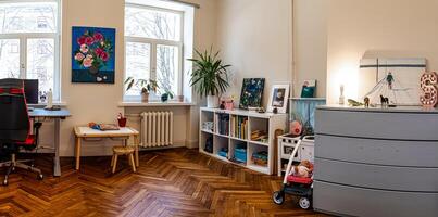 Riga, Latvia, 2024 - Cozy Room with Wooden Flooring and Natural Light from Large Windows photo