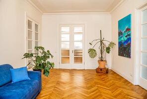 Riga, Latvia, 2024 - Minimalist Interior with Blue Couch and Herringbone Floor photo