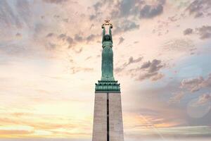 Riga, Latvia, 2024 - Aerial View of Freedom Monument Against Pastel Sky in Riga, Latvia photo