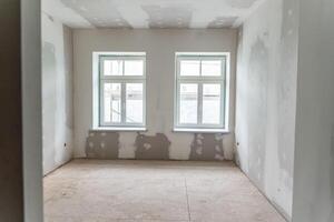 Unfinished Interior Room with Drywall and Two Rectangular Windows photo