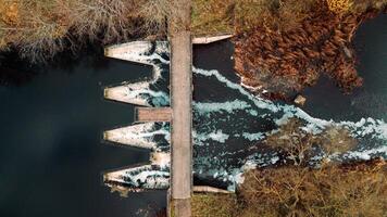 Aerial View of Dam with Triangular Openings and Pedestrian Bridge photo