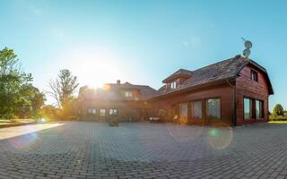 Rustic Wooden House with Gabled Roofs in a Rural Setting photo