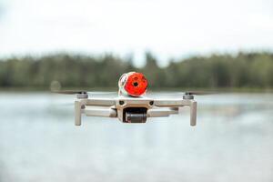 Compact Drone in Flight with Red Circular Object in Natural Setting photo