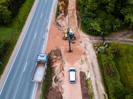 Aerial View of Road Construction Site Next to Two Lane Highway and Forest photo