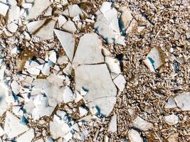 Top Down View of Cracked Ice Sheets with Gravel Fragments photo