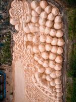 Aerial View of Intricate Sand Sculpture of Grapes in Open Area photo