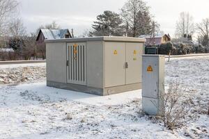 Snow Covered Field with Utility Box and Control Panel in Winter photo