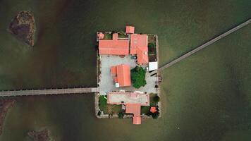 Aerial View of Island with Red Roofed Buildings and Stone Wall photo