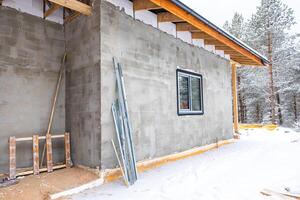Partially Constructed Building in Snowy Forested Setting photo
