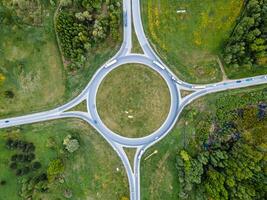 Aerial View of Roundabout Amid Open Fields and Forested Areas photo
