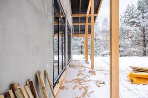 Partially Constructed Building with Glass Windows in Snowy Setting photo