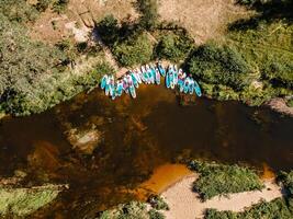Aerial View of Colorful Kayaks and Paddleboards on a Calm River photo