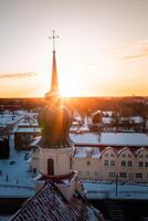 Church with Onion Shaped Dome in Snowy Landscape at Sunrise or Sunset photo