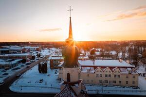 Church with Onion Shaped Dome at Sunset in Snowy Urban Setting photo