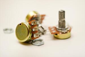 A potentiometer with fasteners. A resistor with a rotator. photo