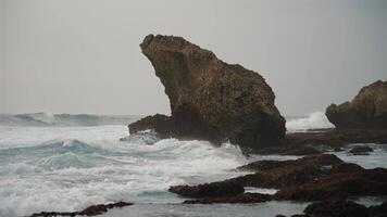 Rocky shore with sharp stones and crashing waves video