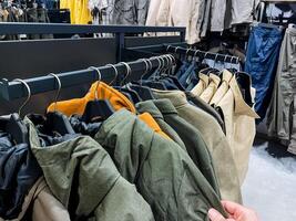 Explore our Stylish Outerwear Collection that showcases a wide range of Diverse Textures and Vibrant Colors, all presented in a chic and Modern Retail Environment photo