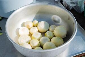 A beautiful bowl of freshly harvested potatoes sits on a rustic wooden table, waiting to be transformed into delightful recipes for everyone to enjoy together in harmony photo