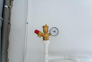 A pressure gauge is currently placed on the upper surface of a pipe, providing essential information about the pressure within the system it is monitoring for proper functionality photo