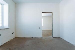 The room has a welldesigned door and large window for natural light, with stunning flooring and elegant ceilings, creating a warm, inviting space for relaxation and socializing photo