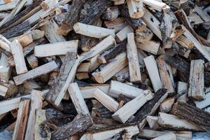 A sizable pile of wood is situated right on top of an additional, similarly large pile of wood, creating a stacked effect that showcases the materials natural composition and structure photo
