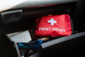 An essential first aid kit is located conveniently in the cars glove box to ensure easy access in case of emergencies or minor injuries that may occur while traveling or during road trips photo