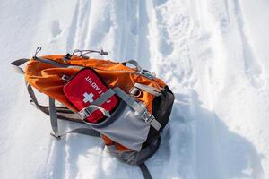 A wellequipped backpack contains a comprehensive first aid kit, ideal for use in snowy environments, providing essential support for hikers and adventurers during winter excursions photo