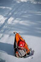 A durable backpack with a first aid kit is shown in a snowy scene, showcasing essential gear for winter adventures and ensuring safety during cold hikes in tough weather photo