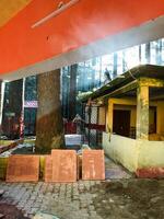 A distinctive building features a uniquely designed roof with vibrant orange and yellow colors, creating a striking visual appeal that attracts attention and leaves a lasting impression photo