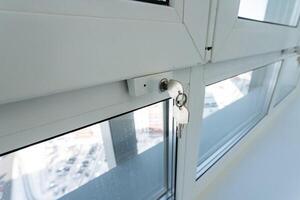 The image captures a closeup view of a window that features a key inserted into it, highlighting the intricate details of the surrounding area. Its a scene that evokes a sense of security photo