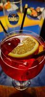 Red coctail with ice and lemon photo