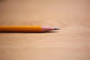 Yellow sharp pencil on the desk photo