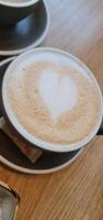 Cup of coffee with heart in foam photo