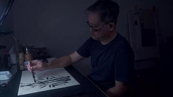 An Asian Artist Creating Ink Lines in Dimly Lit Studio, Part 4 video