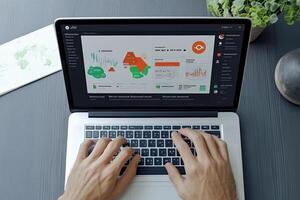 Businessman analyses advanced financial data and graphs on a laptop photo