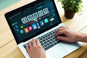 Businessman works on a sleek laptop creating a flow chart photo