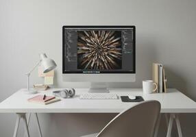 Clean white desk with an monitor displaying an abstract art design in a modern workspace. photo