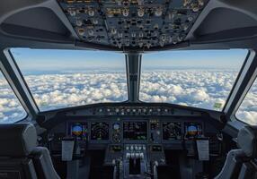 Dramatic view from an airplane cockpit, showcasing fluffy clouds stretching to the horizon. photo