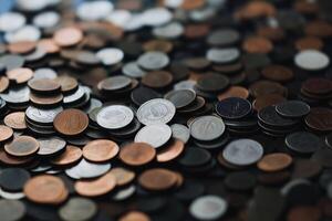 A variety of global coins are scattered, representing currency and economic concepts. photo