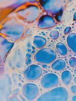 A close-up reveals a stunning tapestry of blue and gold bubbles creating an abstract pattern. photo
