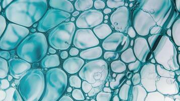 A mesmerizing close-up of interconnected blue bubbles forms an abstract, cellular design. photo