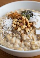 Start your day right with a nutritious bowl of oatmeal topped with hazelnuts and seeds. photo