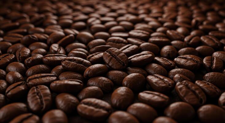 Aromatic roasted coffee beans fill the frame, promising a rich and flavorful experience.