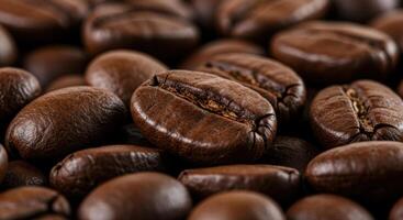 Aromatic roasted coffee beans are displayed in a close-up shot, exhibiting rich textures. photo