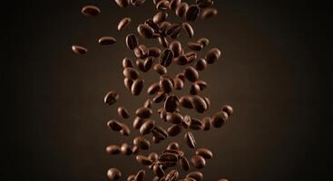 Roasted coffee beans are falling against a brown background with dramatic lighting. photo