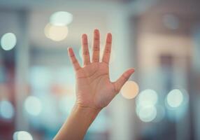 A hand held up, fingers spread, creating a sense of connection and positive affirmation. photo
